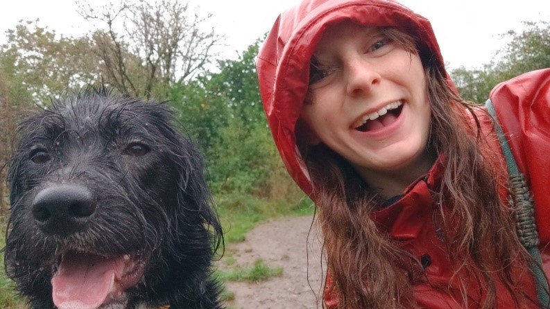 Bryony in a red raincoat with Bernard by her side