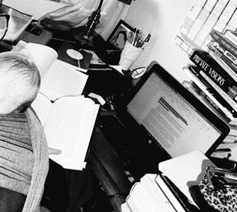 A black and white photo of a busy desk