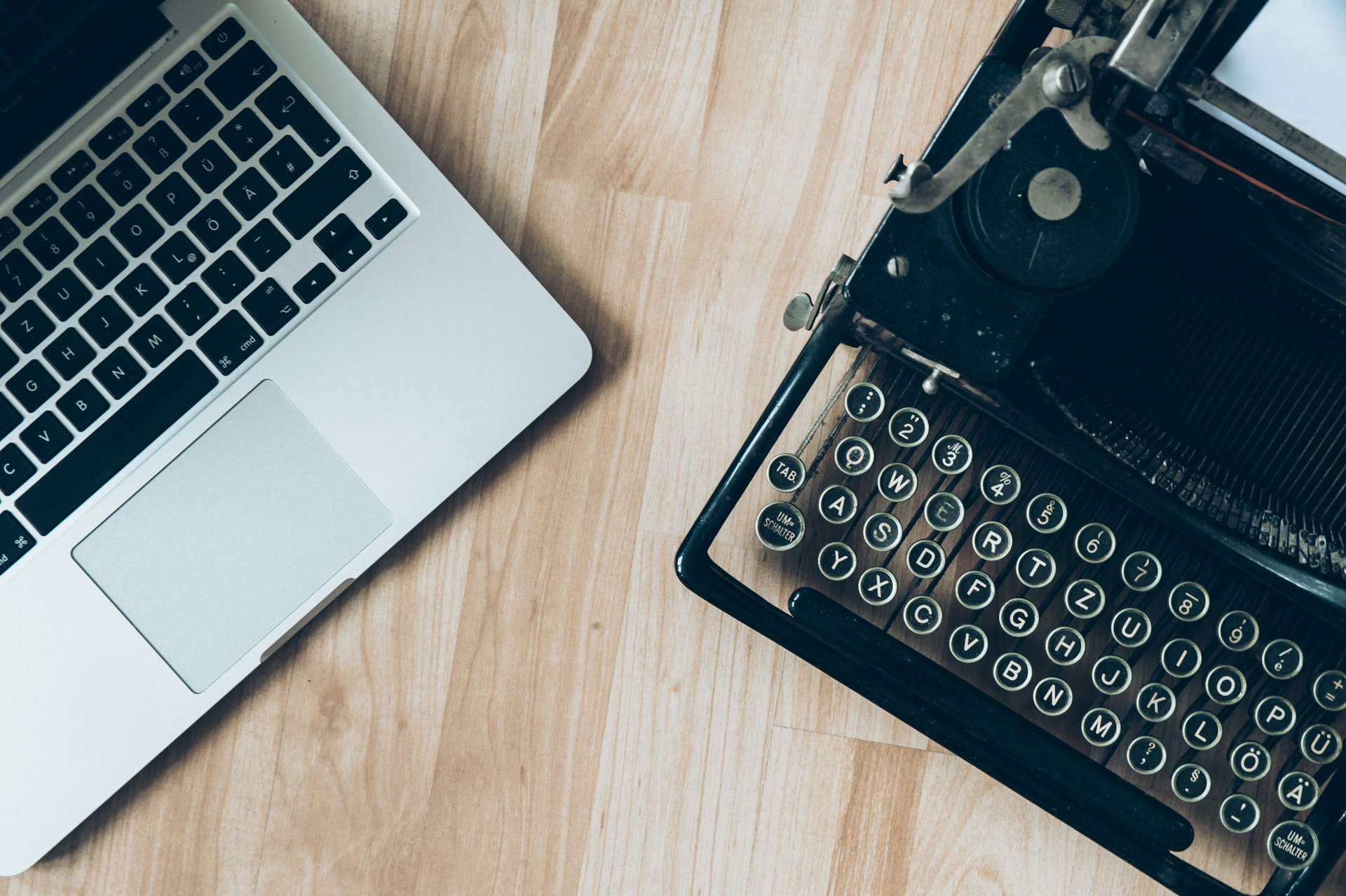 A laptop and an old-fashioned typewriter