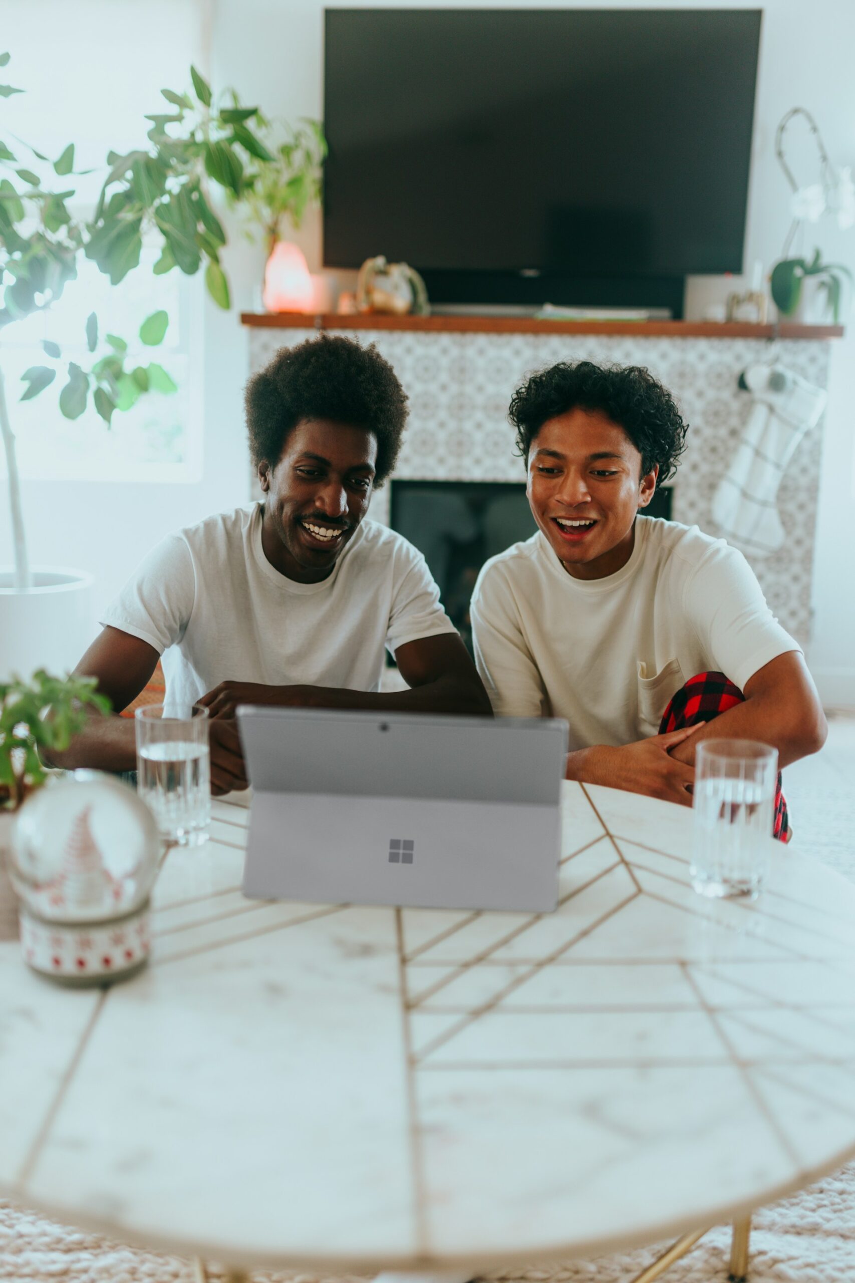 Two people working together in front of a laptop