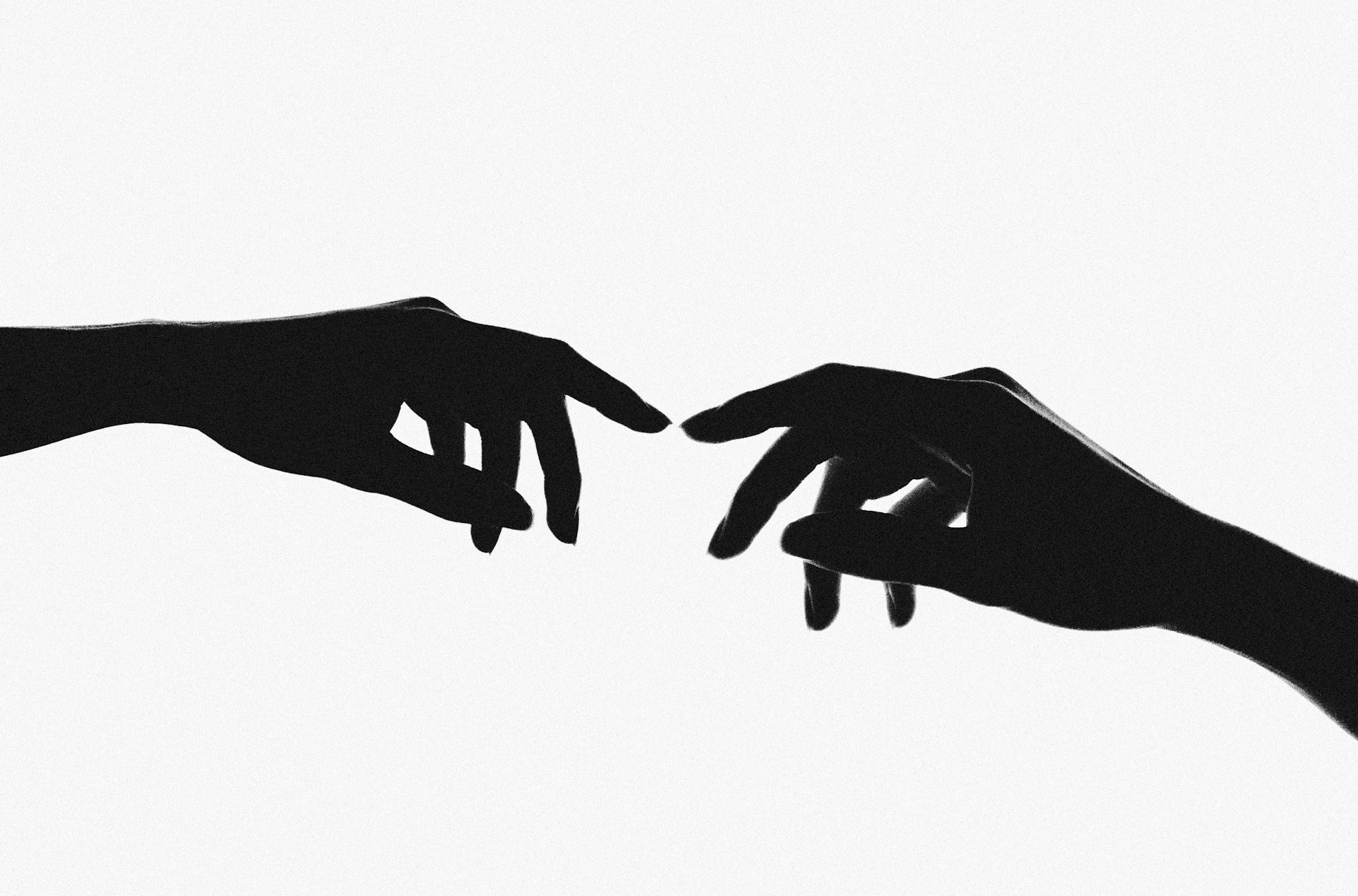 Image of two hands with index fingers nearly touching